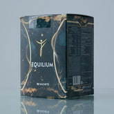 Box of Equilibrium with gold accents on a reflective surface